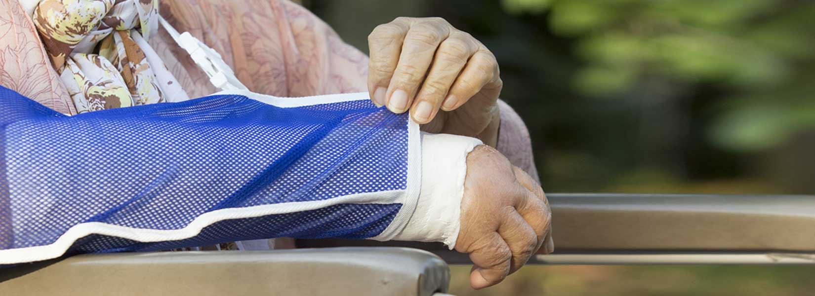 An elderly woman with a cast on her arm