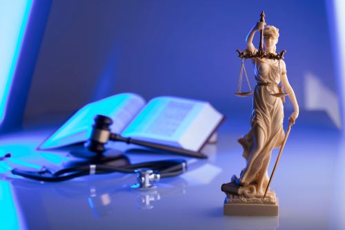 Lady Justice, gavel, stethoscope and a book