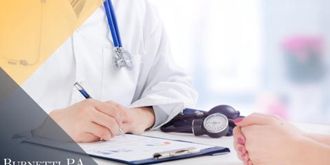 doctor writing on a chart