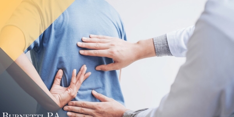 doctor checking patient's back
