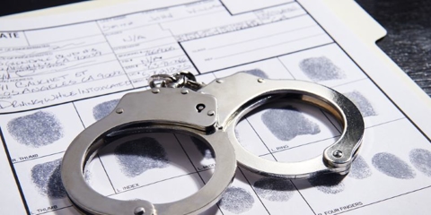 Handcuffs on top of a fingerprint document