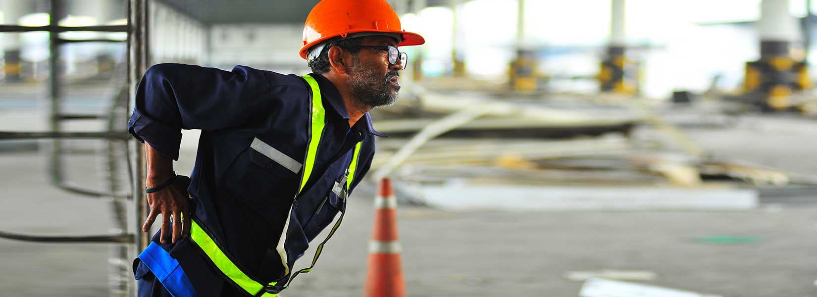 Construction worker holding his lower back