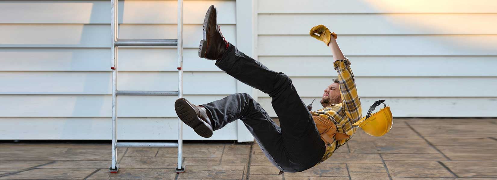 A construction worker falling off a ladder