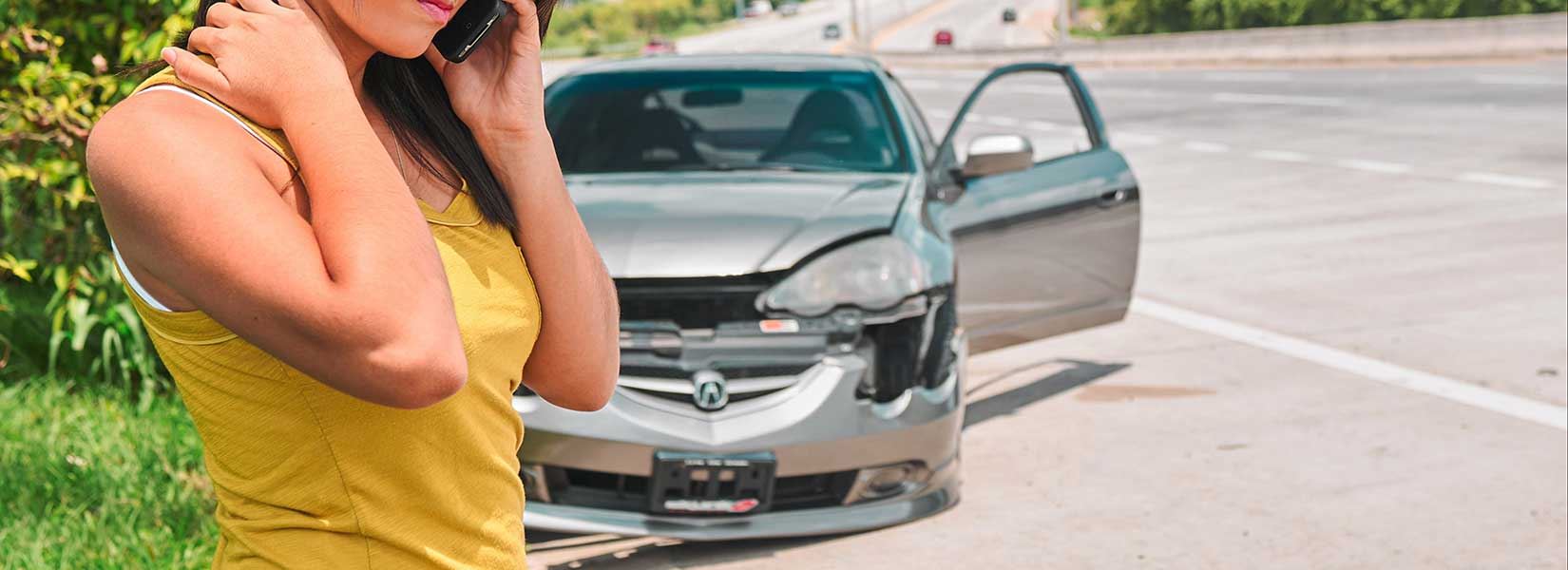 A woman on the phone after a car accident