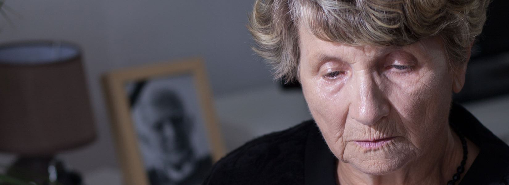 An elderly woman sitting looking at something