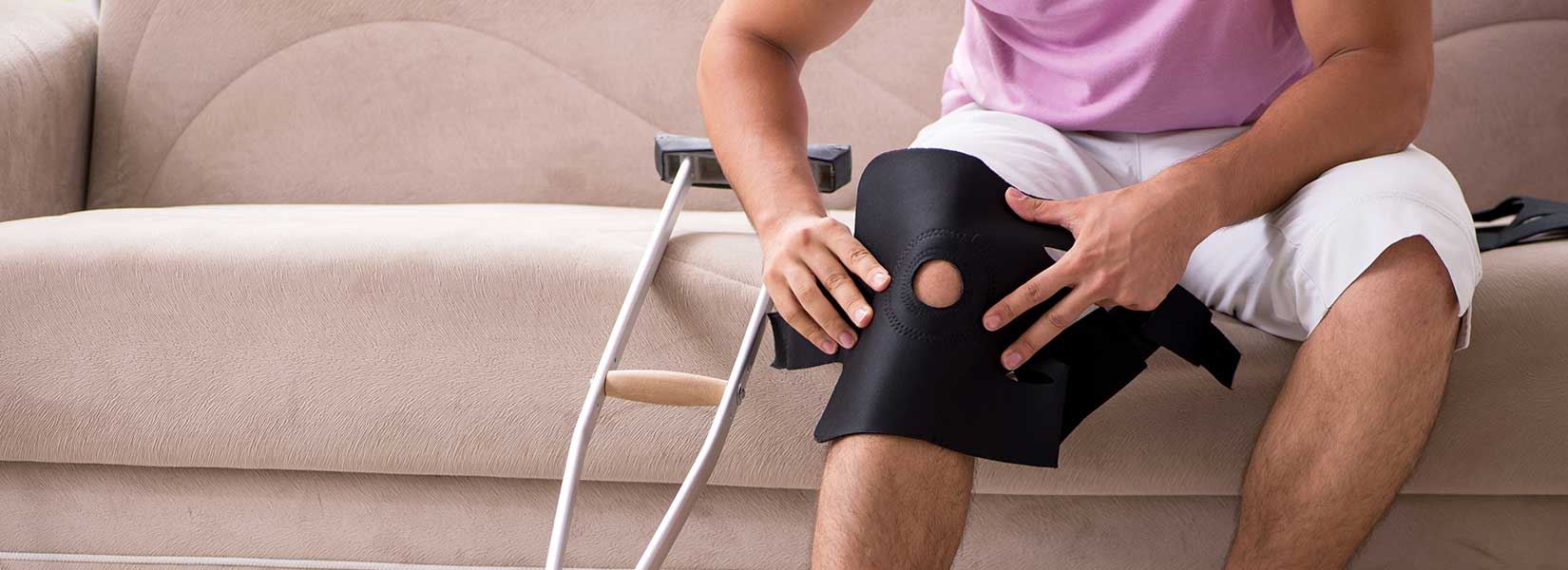 Man putting on a knee brace