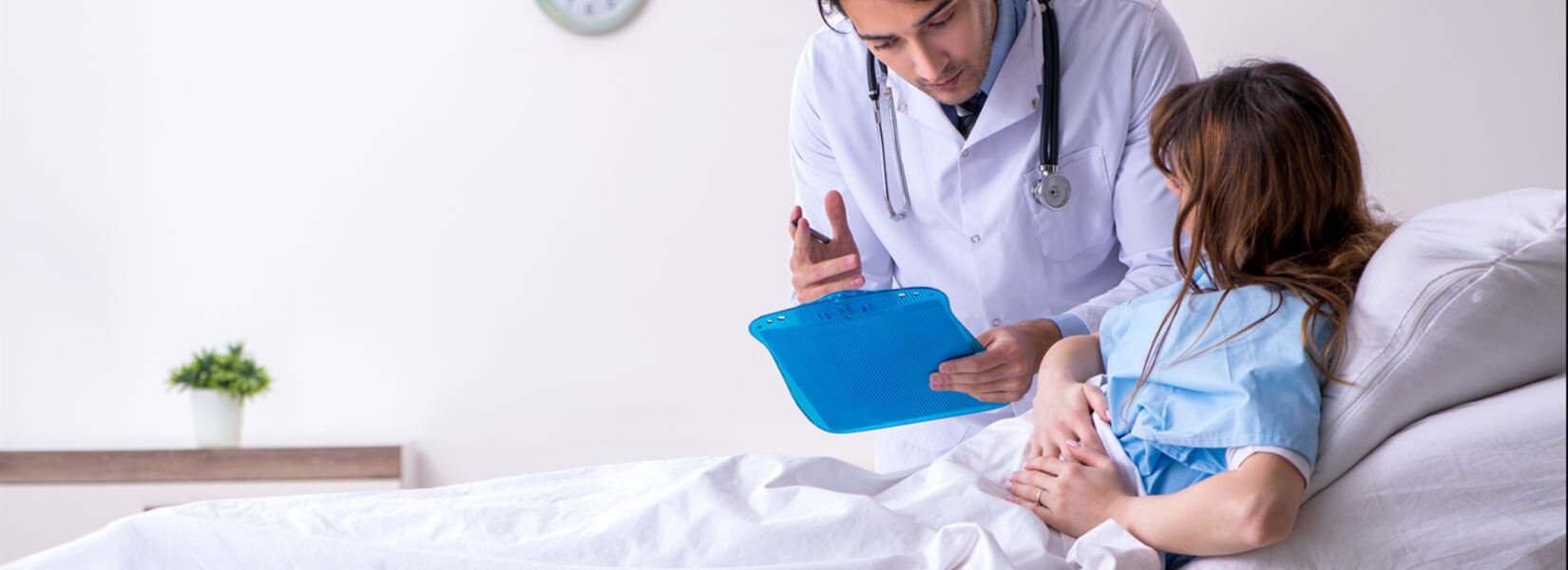 Patient sitting in a hospital bed talking to a doctor