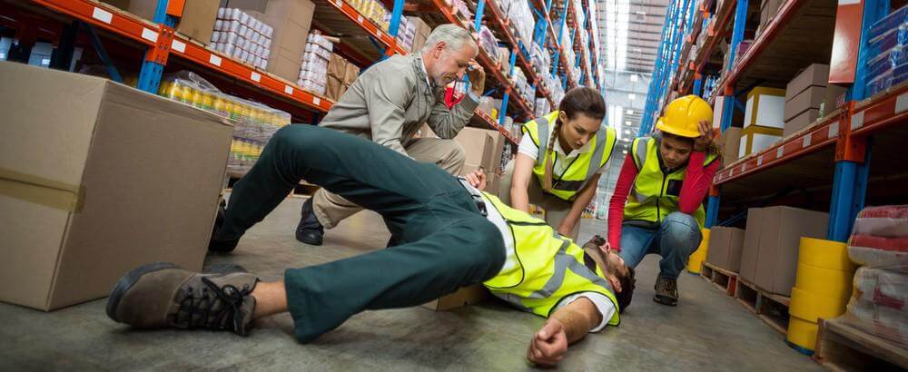 Coworkers surrounding a fall coworker