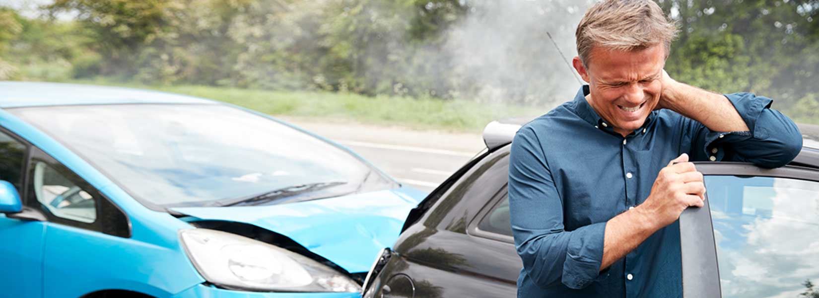 Man holding his head after a car accident