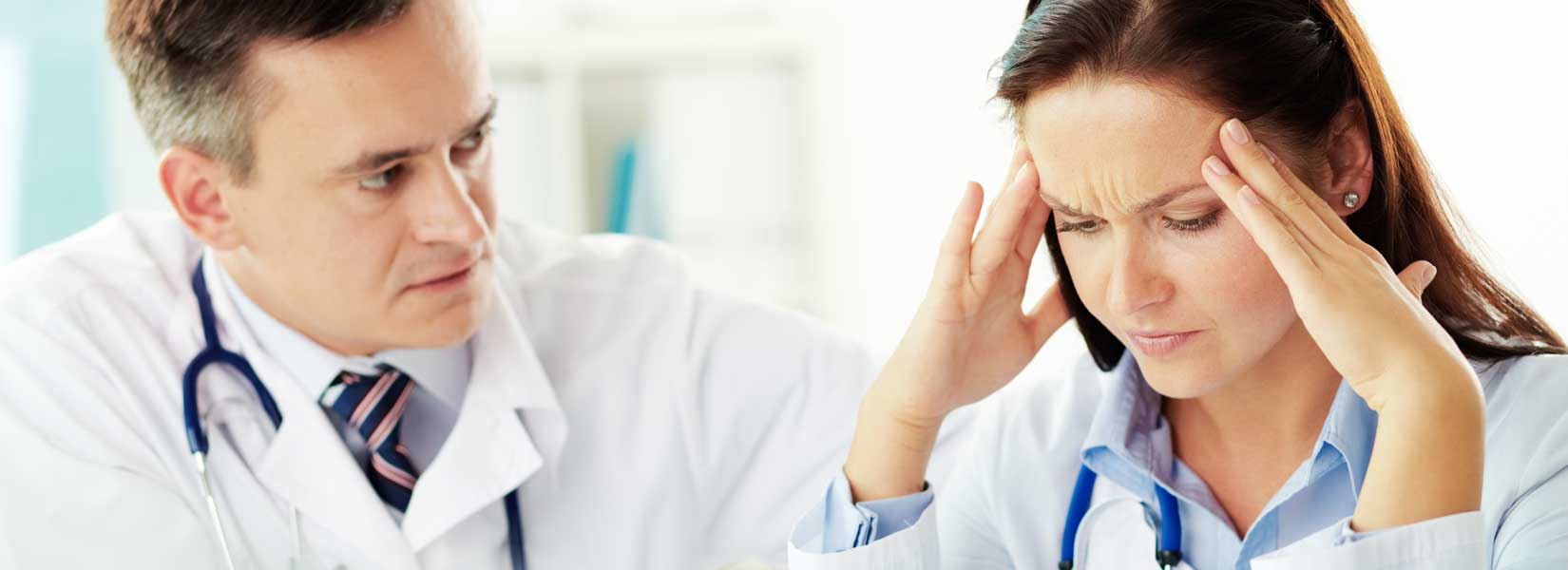 Two doctors sitting next to each other looking at something