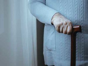 older woman holding a cane