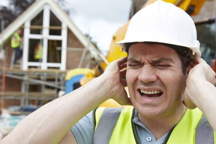 Construction working holding his head